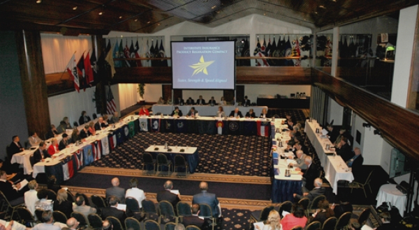 balcony view of a bunch of people meeting in a large conference room