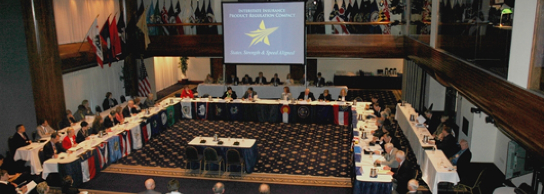 balcony view of a bunch of people meeting in a large conference room