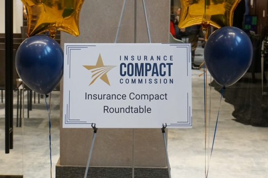 Sign that says "Insurance Compact Roundtable"