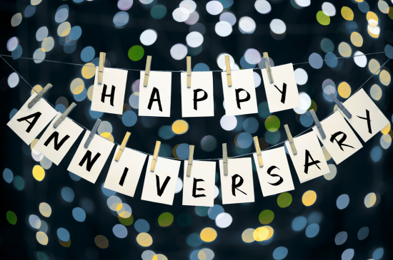 Banner stating "Happy Anniversary" against backdrop of colorful dots
